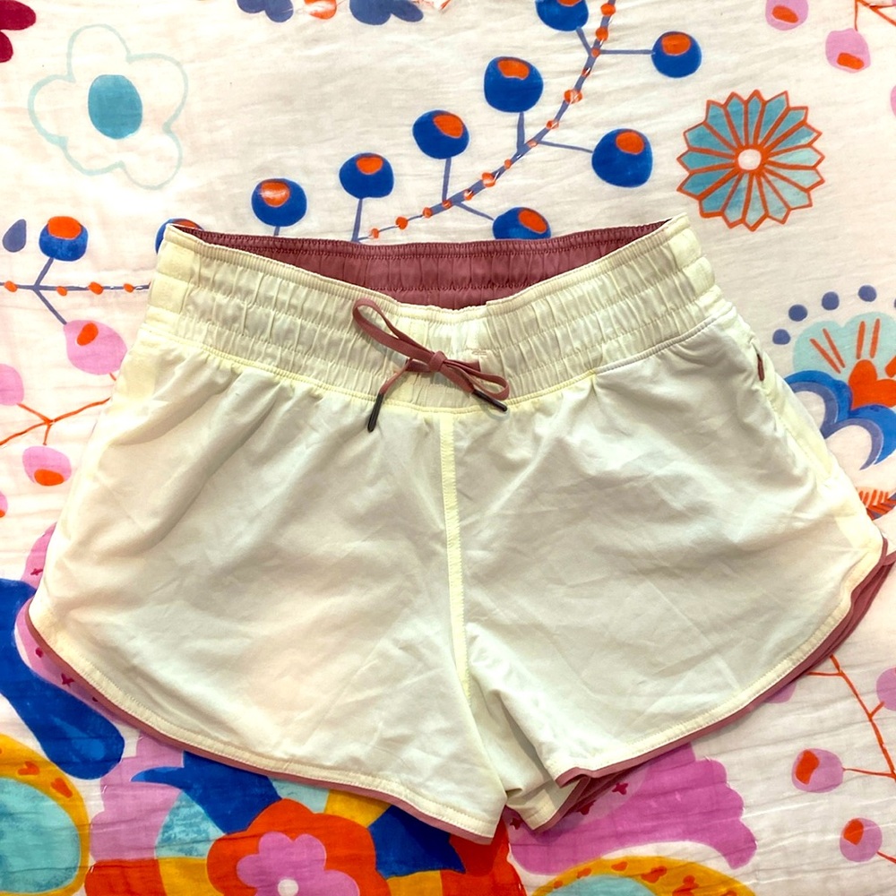 Size S Lululemon Reversible Shorts. Never worn, light yellow and dusty rose.
